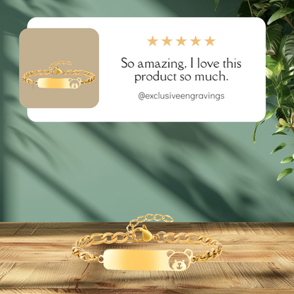 Gold bracelet with engraving on a wooden surface with a green leafy background