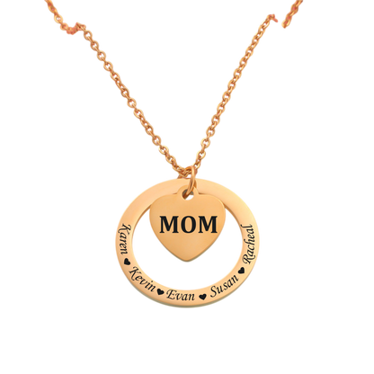 Gold necklace with a heart-shaped pendant displaying 'MOM' on a white background