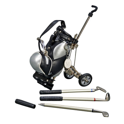 A golf bag with a silver and black color scheme, integrated with a small golf cart handle and wheels, alongside three golf pens.