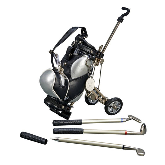 A golf bag with a silver and black color scheme, integrated with a small golf cart handle and wheels, alongside three golf pens.